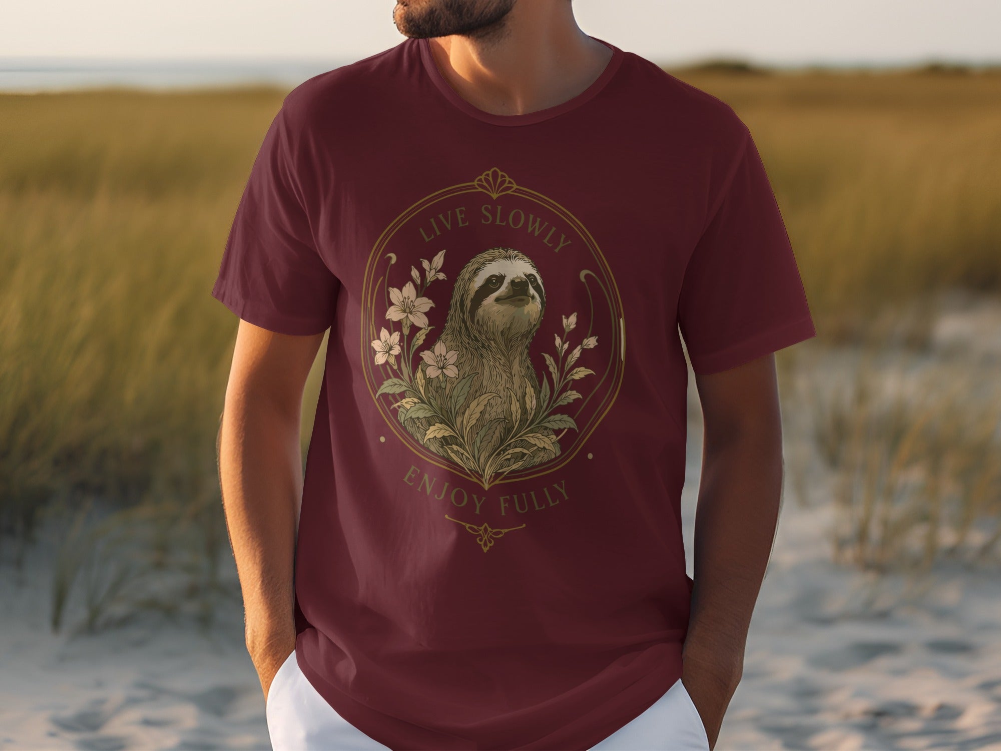 Maroon t-shirt with a circular graphic of a sloth and flowers, text "LIVE SLOWLY ENJOY FULLY".