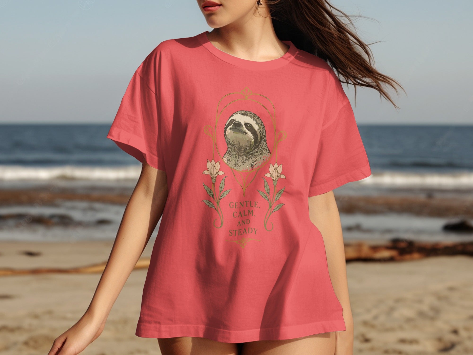 Coral t-shirt with sloth and floral design, "Gentle, Calm, and Steady" text.