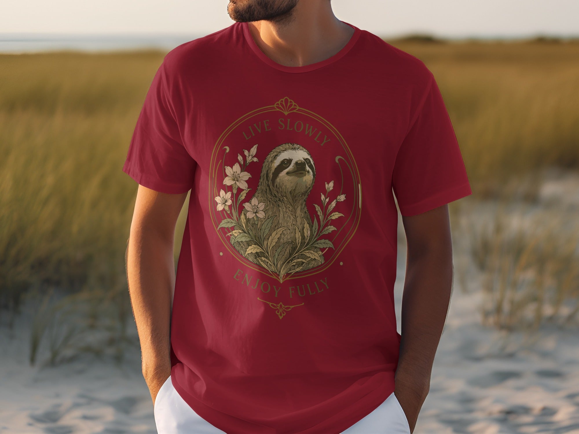 Red t-shirt with a sloth and floral design, featuring text "Live Slowly Enjoy Fully".