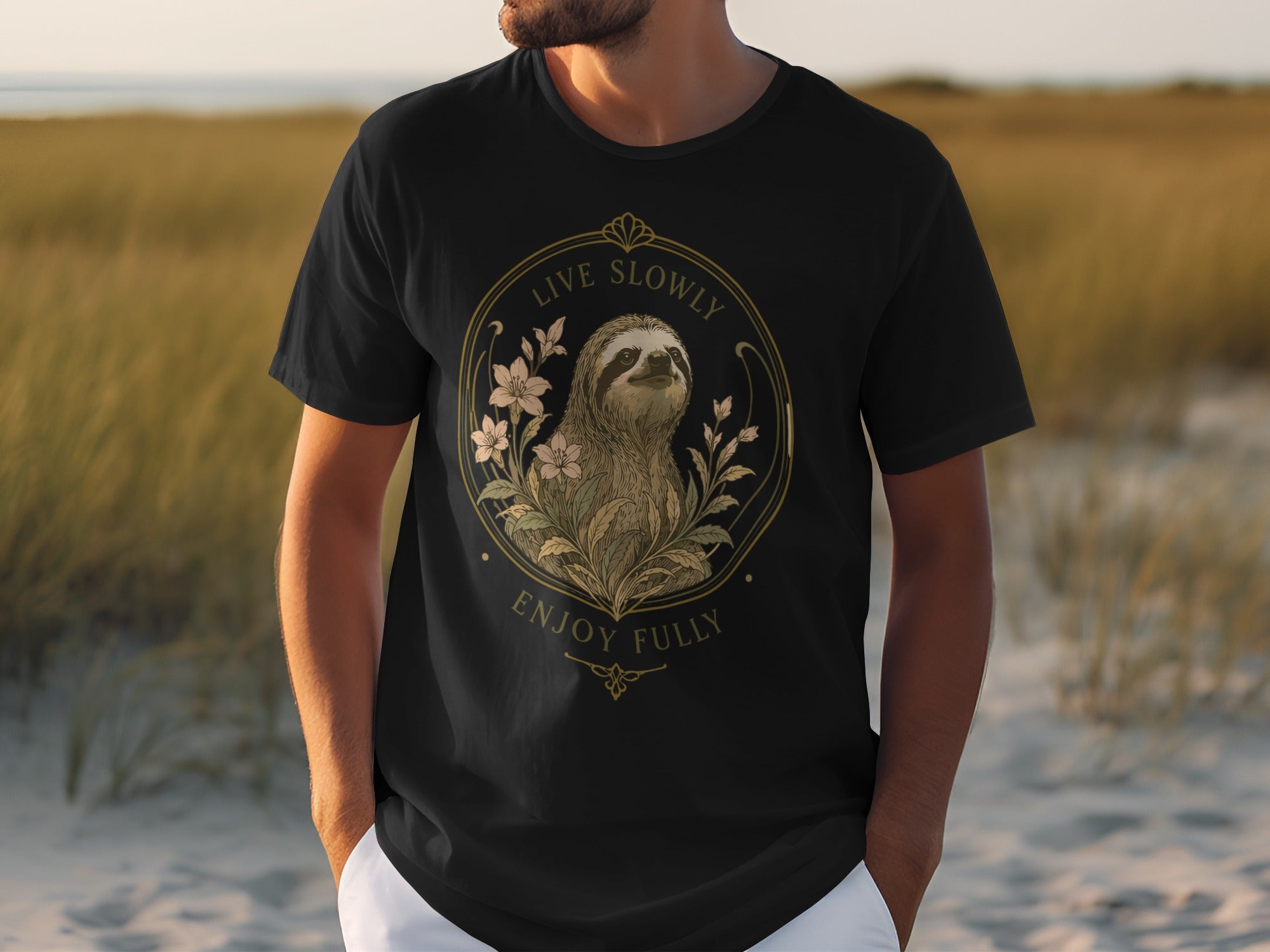 Black t-shirt with sloth and floral design, "Live Slowly Enjoy Fully" text.