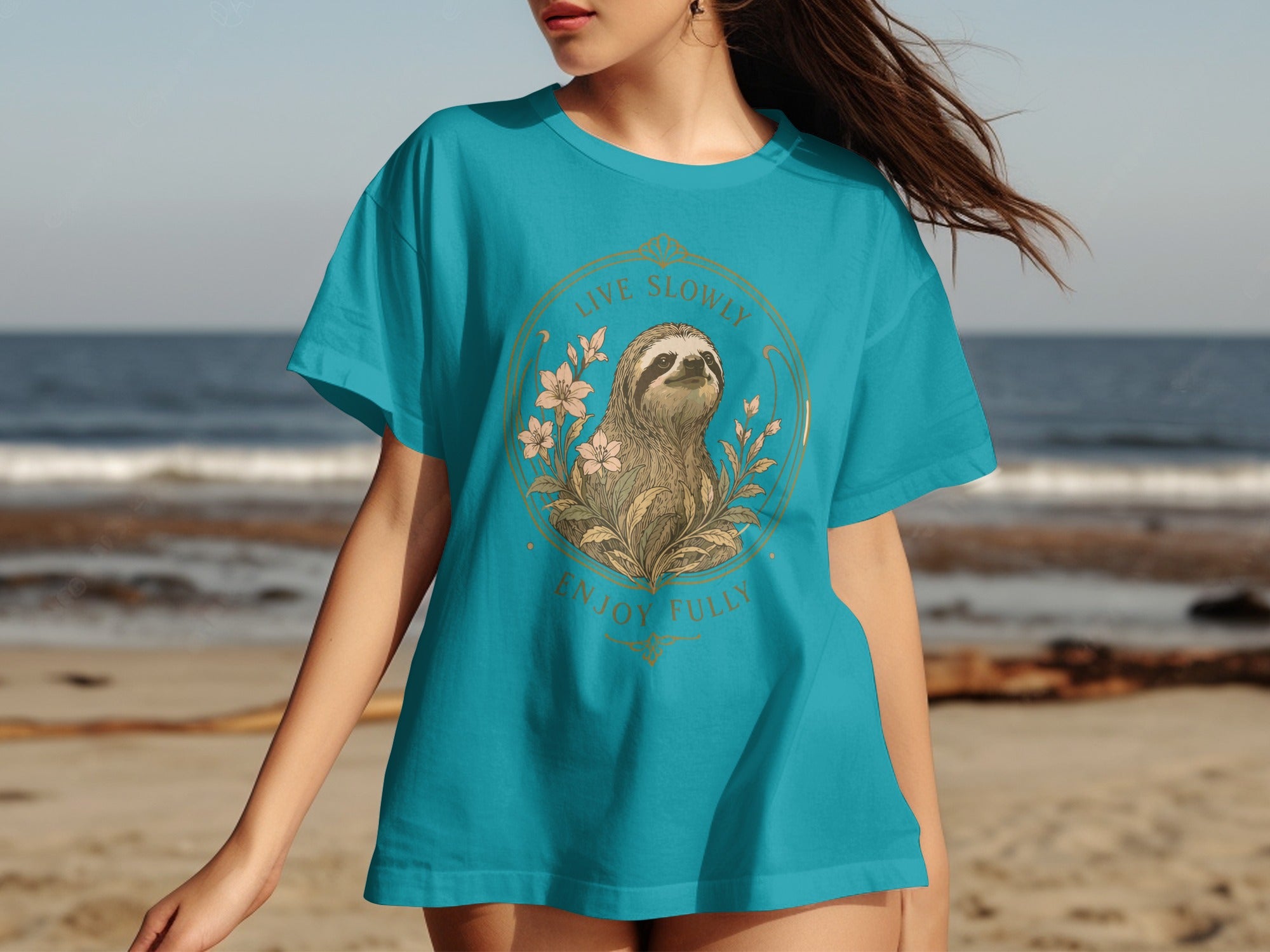 Teal t-shirt featuring a sloth illustration with text "LIVE SLOWLY ENJOY FULLY".