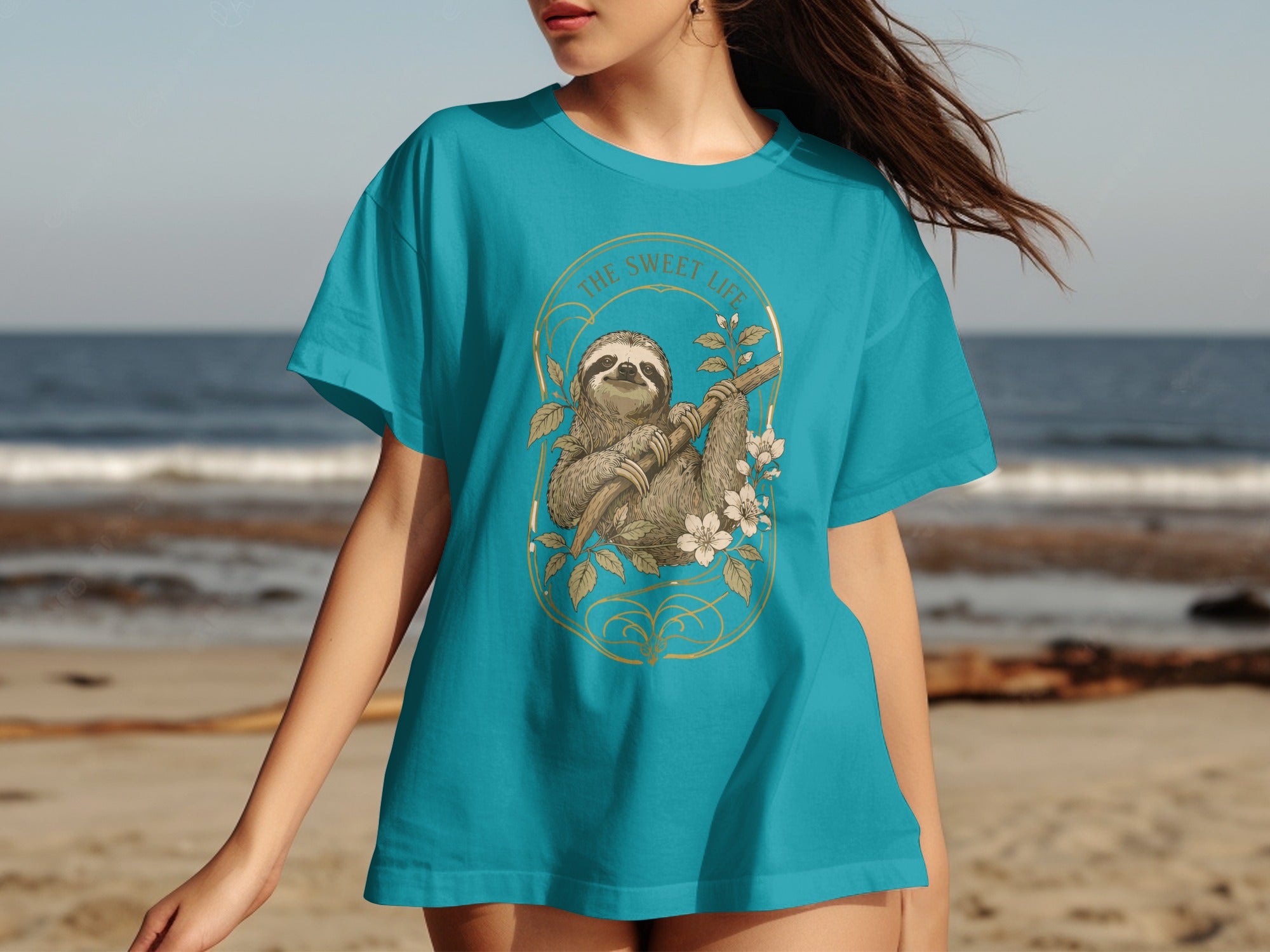 Turquoise t-shirt with a sloth hanging from a branch and flowers.