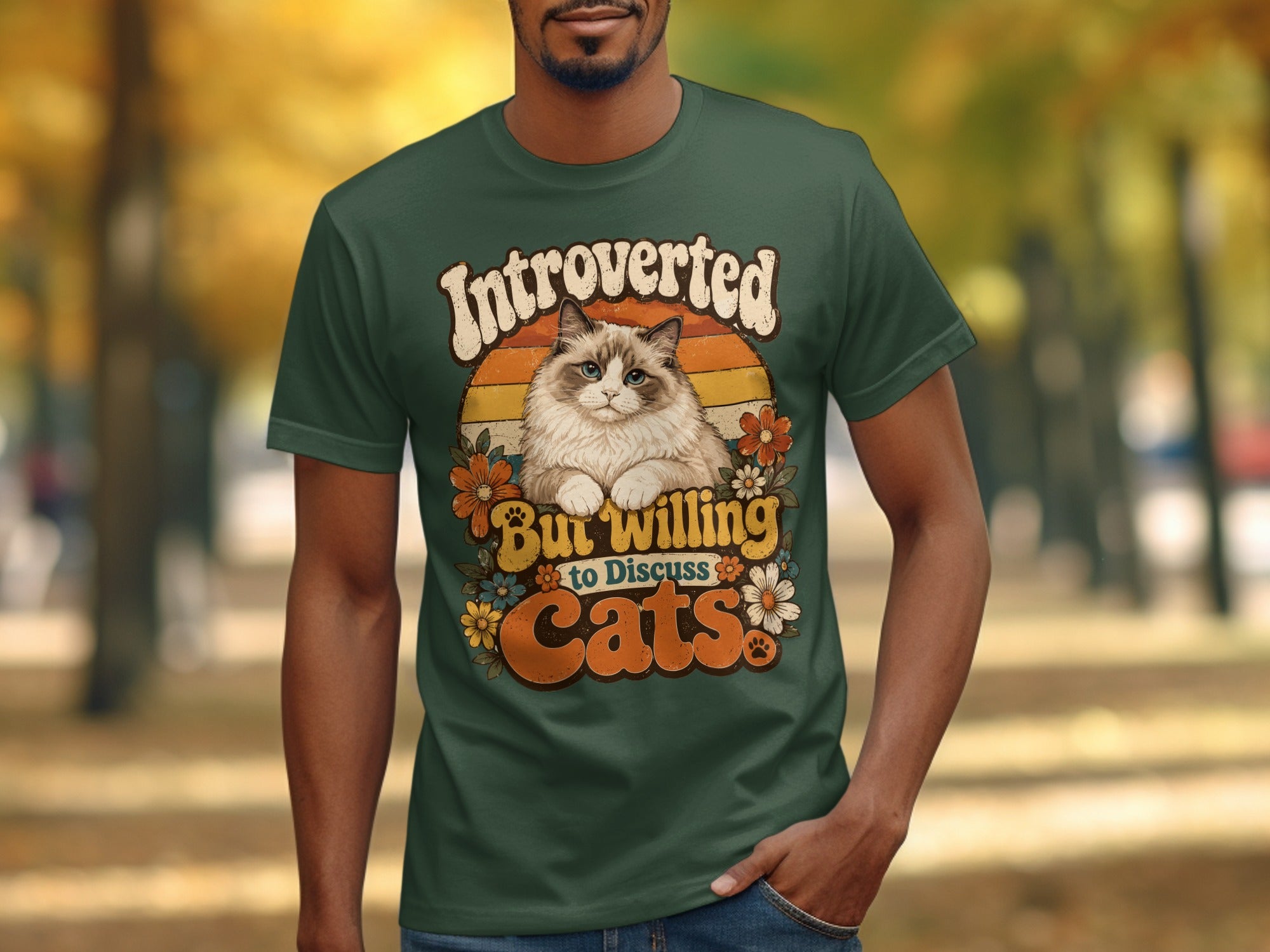 Green t-shirt with a cat graphic and text "Introverted But Willing to Discuss Cats."