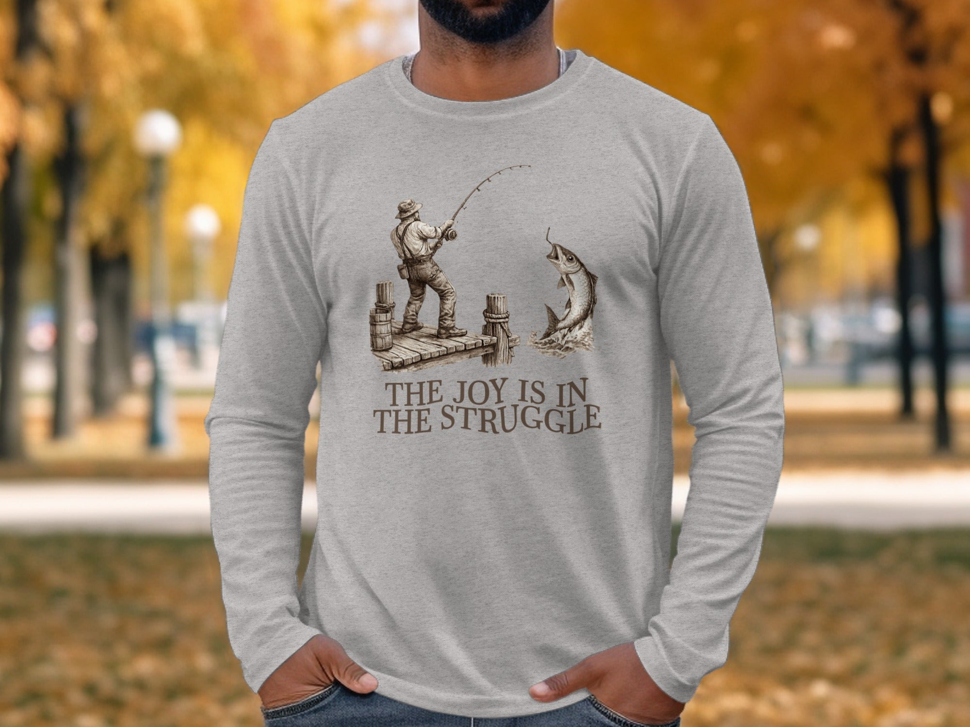 Gray long-sleeve shirt with a fisherman reeling in a jumping fish.