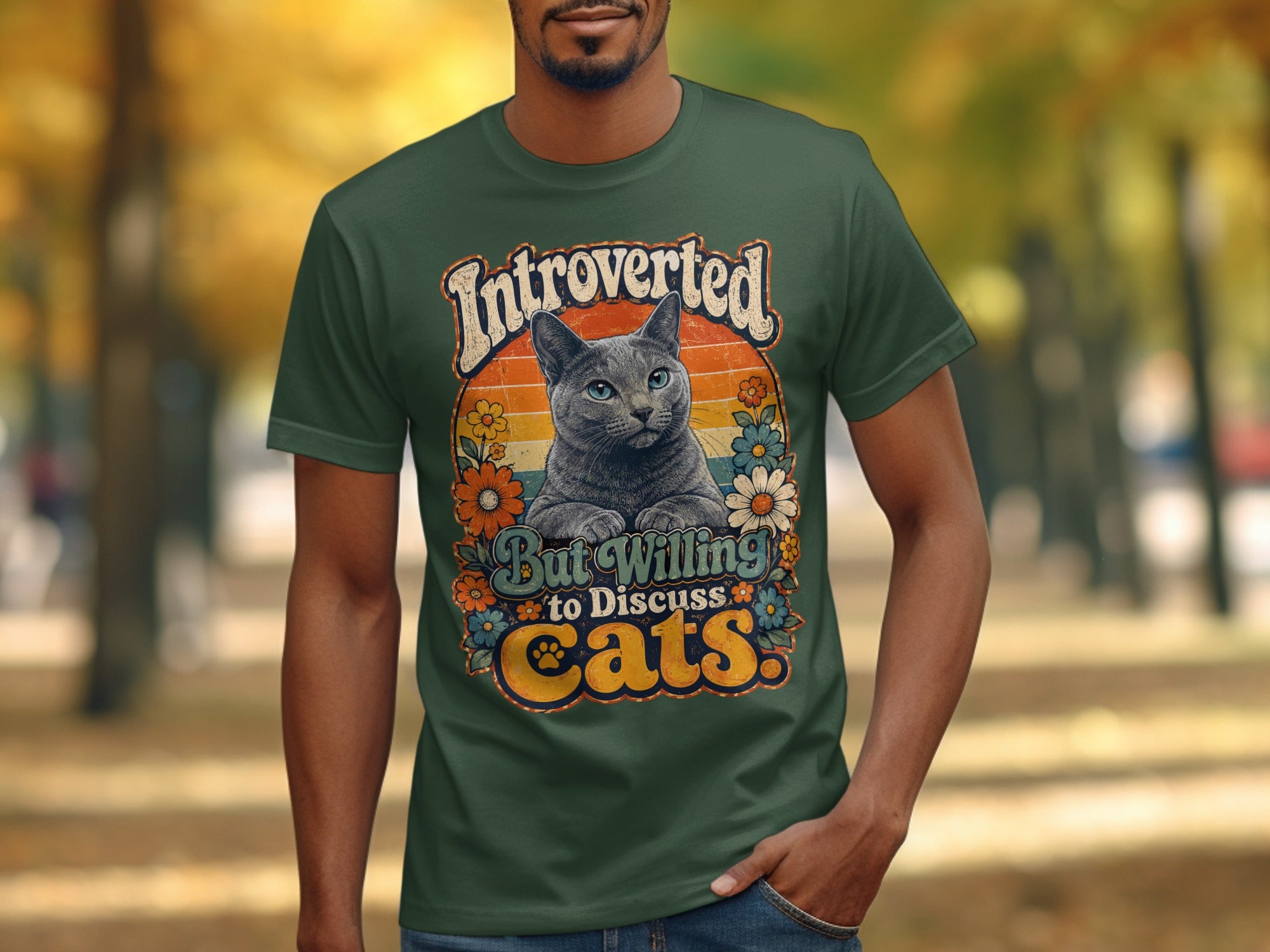 Green t-shirt with "Introverted but willing to discuss cats" text and a cat illustration.