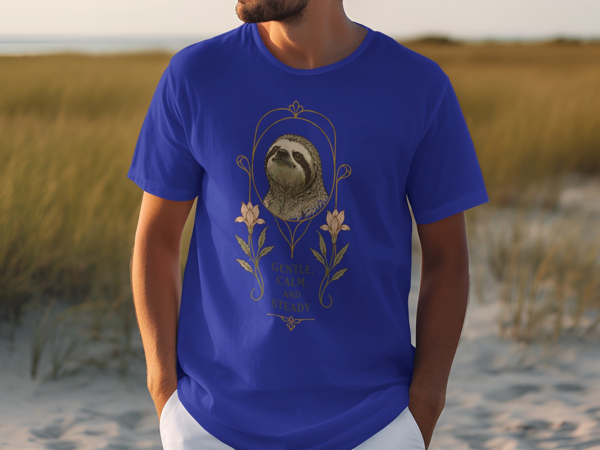 Blue t-shirt with sloth graphic and text "Gentle, Calm, and Steady".