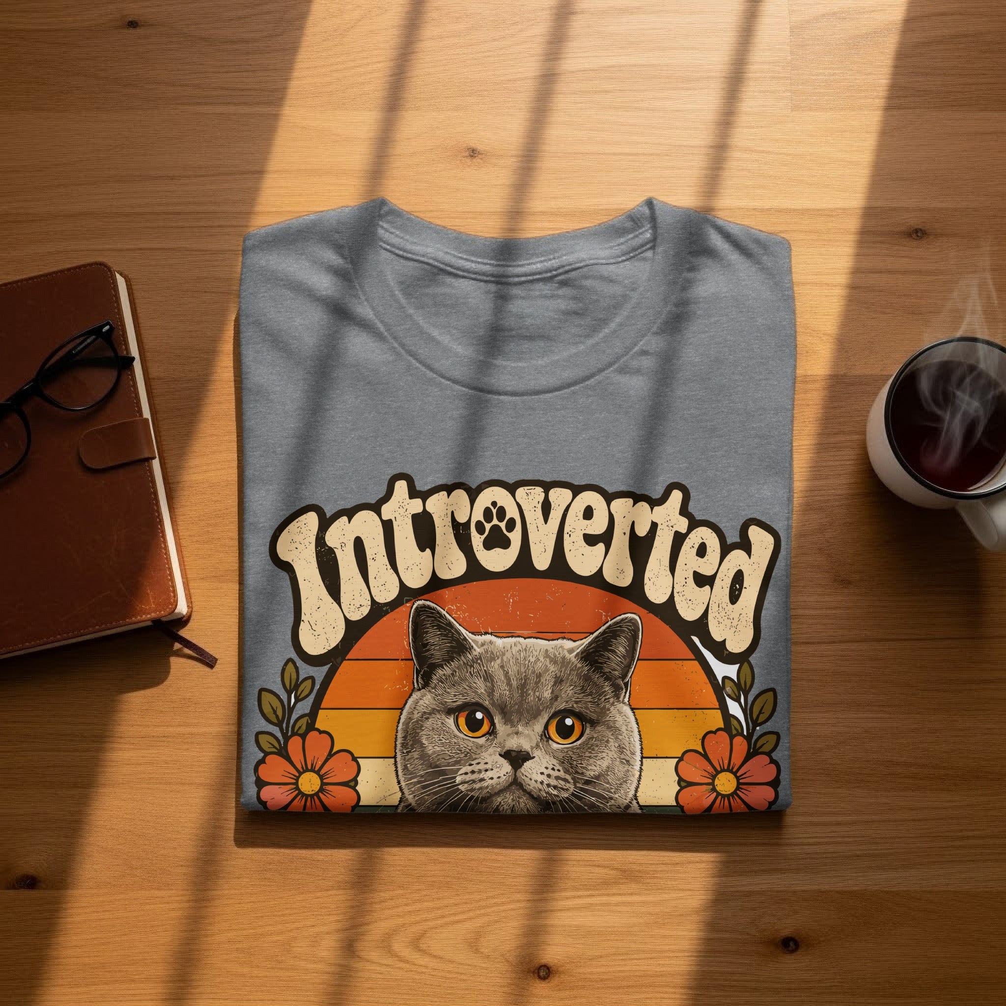 Gray t-shirt with "Introverted" text and a cat peeking from behind flowers.