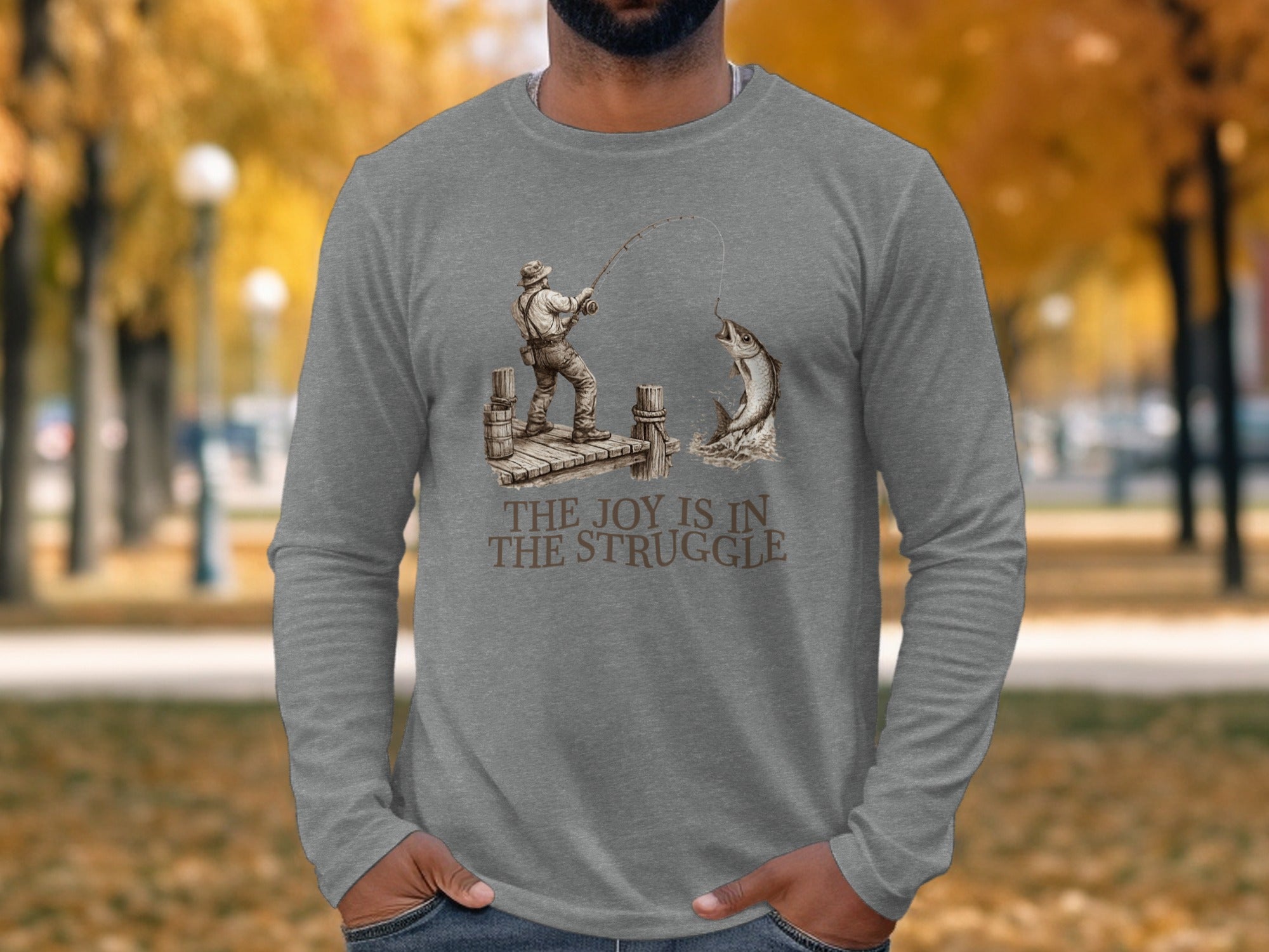 Man wearing a grey long-sleeve shirt with a fishing graphic and text.