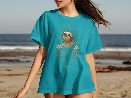 Teal t-shirt with a sloth illustration and "Gentle, Calm and Steady" text.