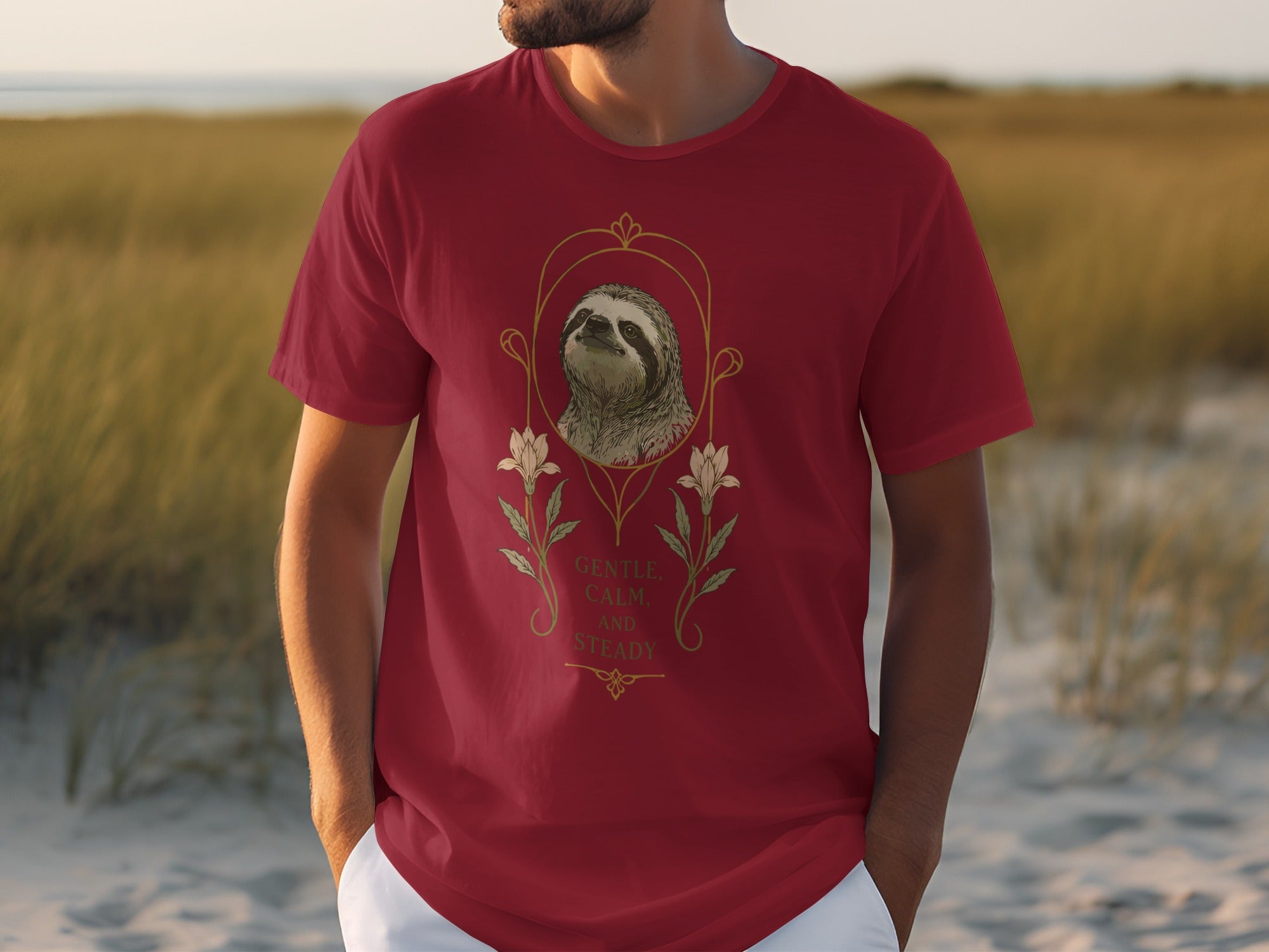 Red t-shirt featuring a sloth portrait and floral design with text.