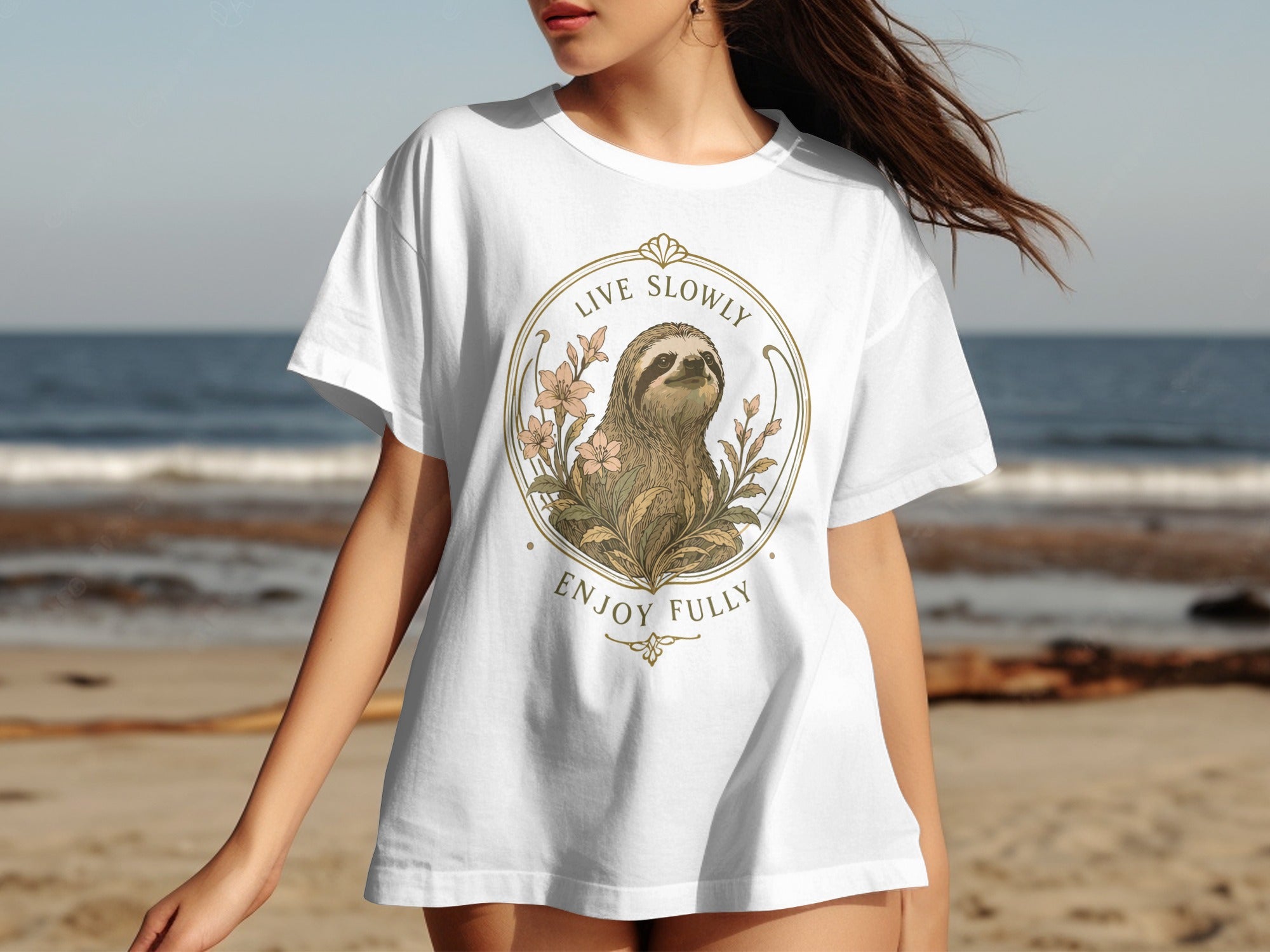 White t-shirt with a sloth and flowers design, text "LIVE SLOWLY ENJOY FULLY".