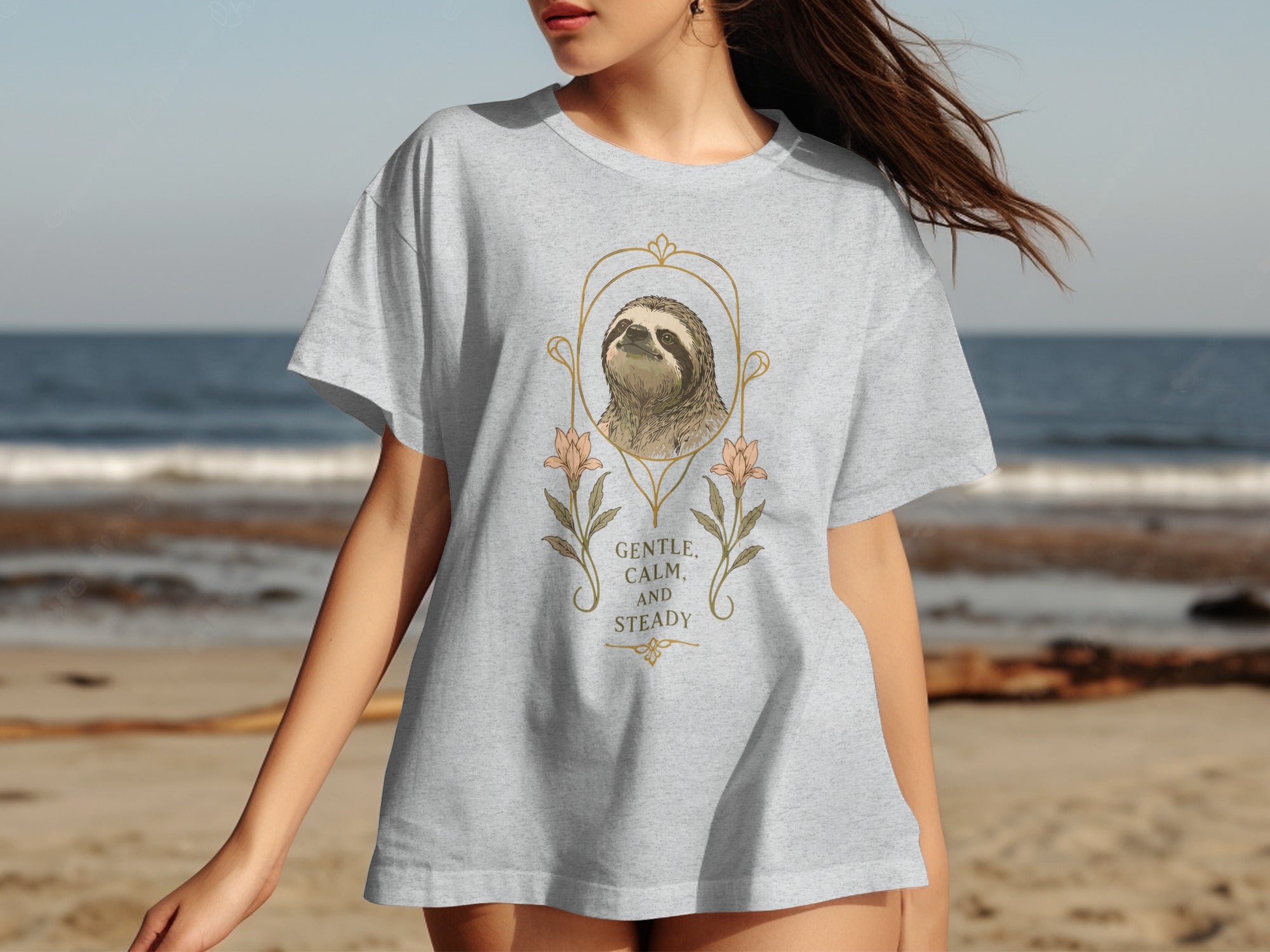 Gray t-shirt featuring a sloth illustration with floral accents and the text "GENTLE, CALM AND STEADY."