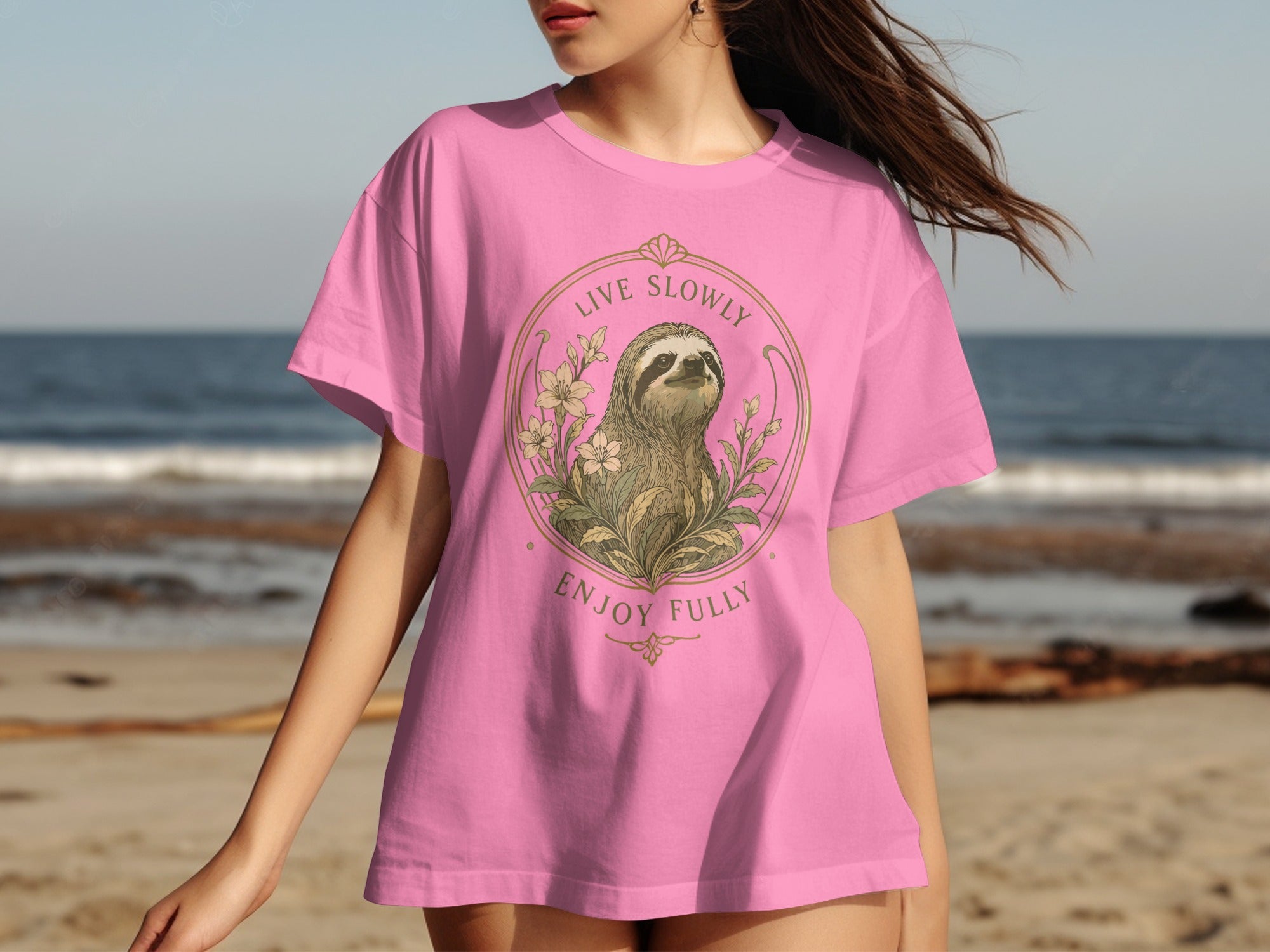 Pink t-shirt featuring a sloth illustration with "Live Slowly Enjoy Fully" text.