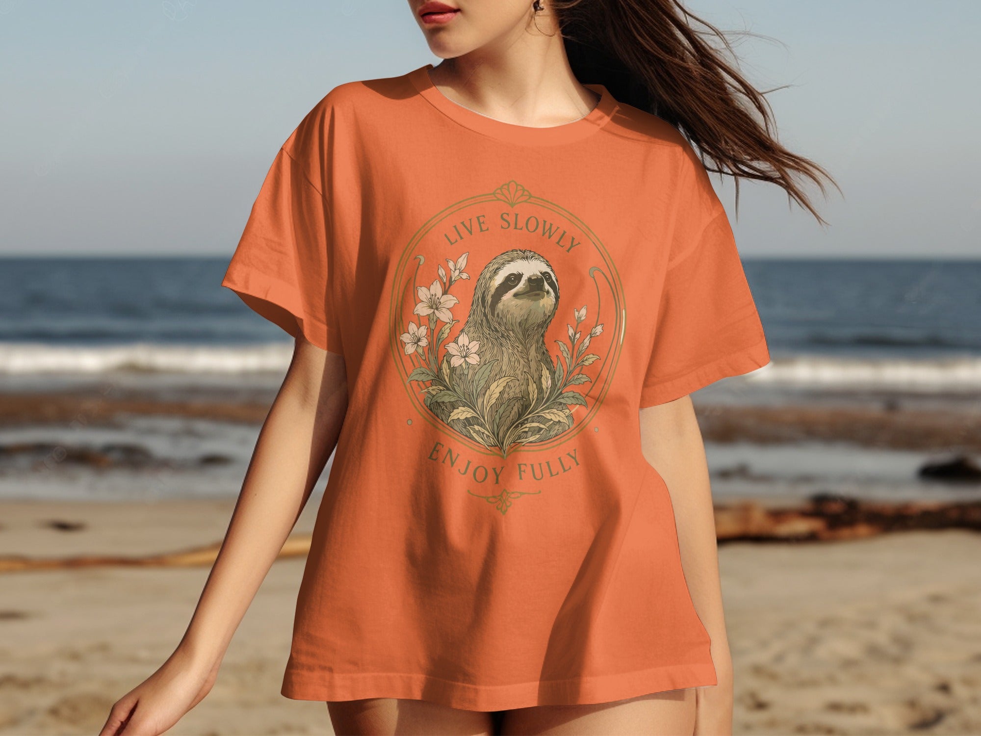 Orange t-shirt with sloth, flowers, and text "Live Slowly Enjoy Fully".