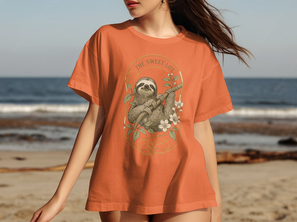 Orange t-shirt with sloth, flowers, and "THE SWEET LIFE" text in a circular emblem.