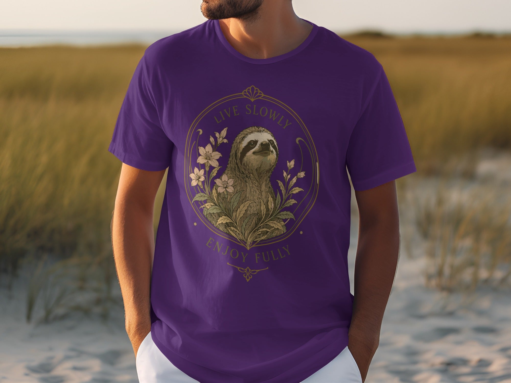 Purple t-shirt with a circular sloth and floral design featuring "Live Slowly Enjoy Fully."