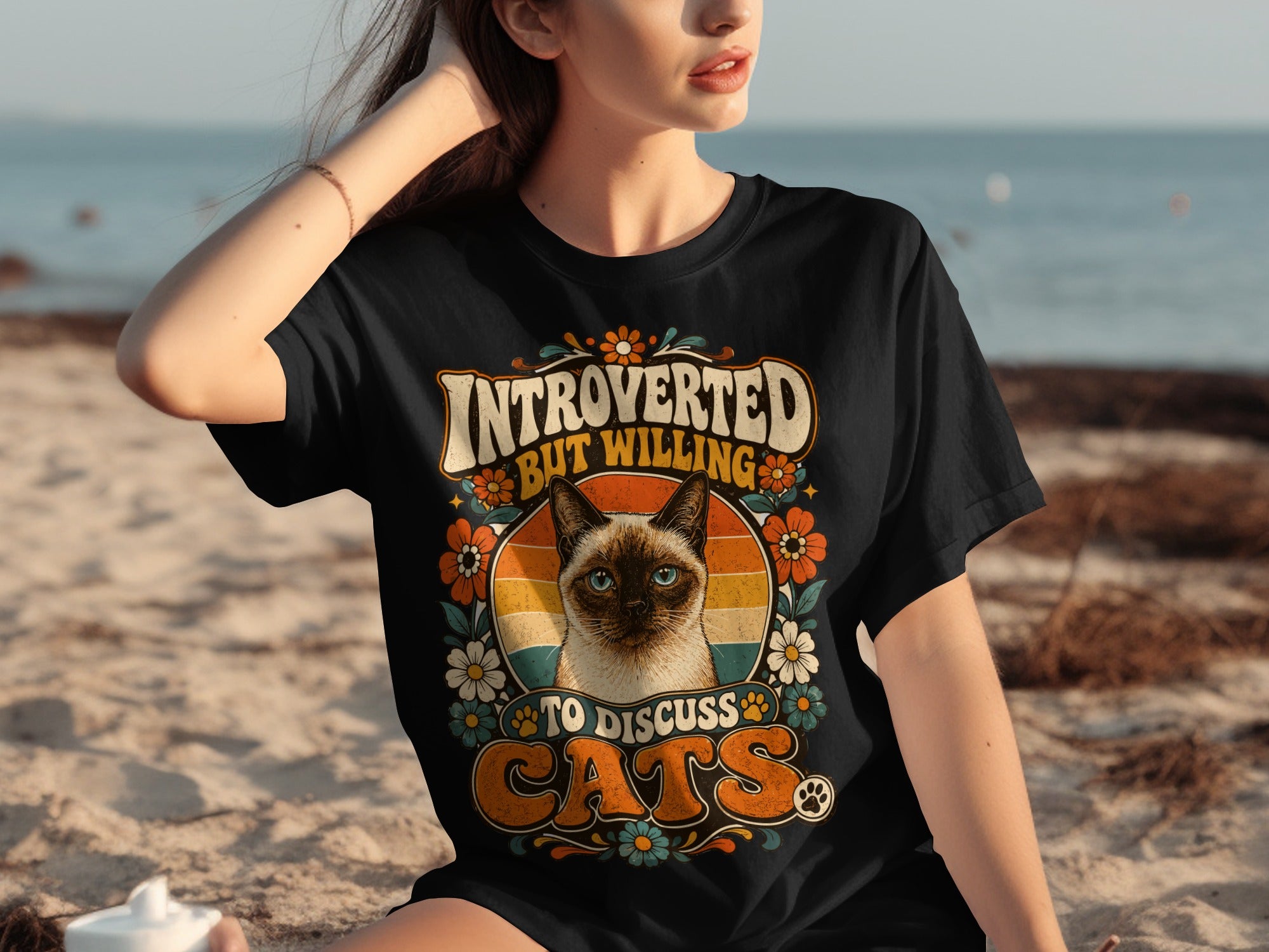 Black t-shirt with cat and flowers, text reads "INTROVERTED BUT WILLING TO DISCUSS CATS".